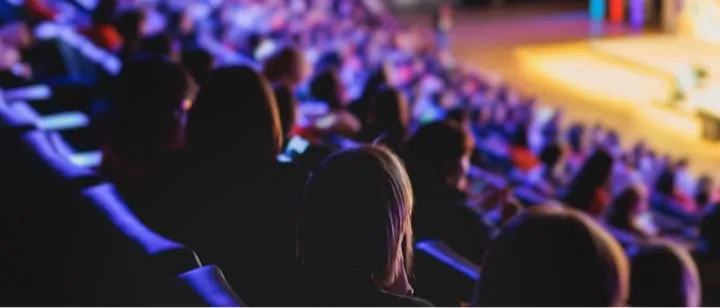 Stock image of an audience watching a panel